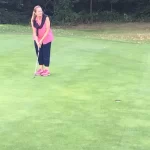 Image of a woman putting on a green during a Love.golf group class