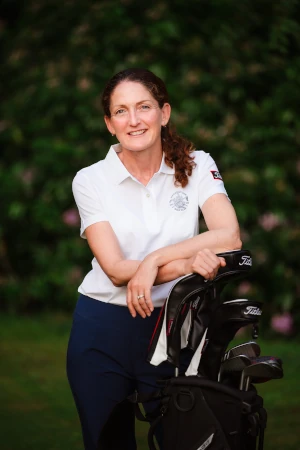 Kellie Leaning on a Golf Bag